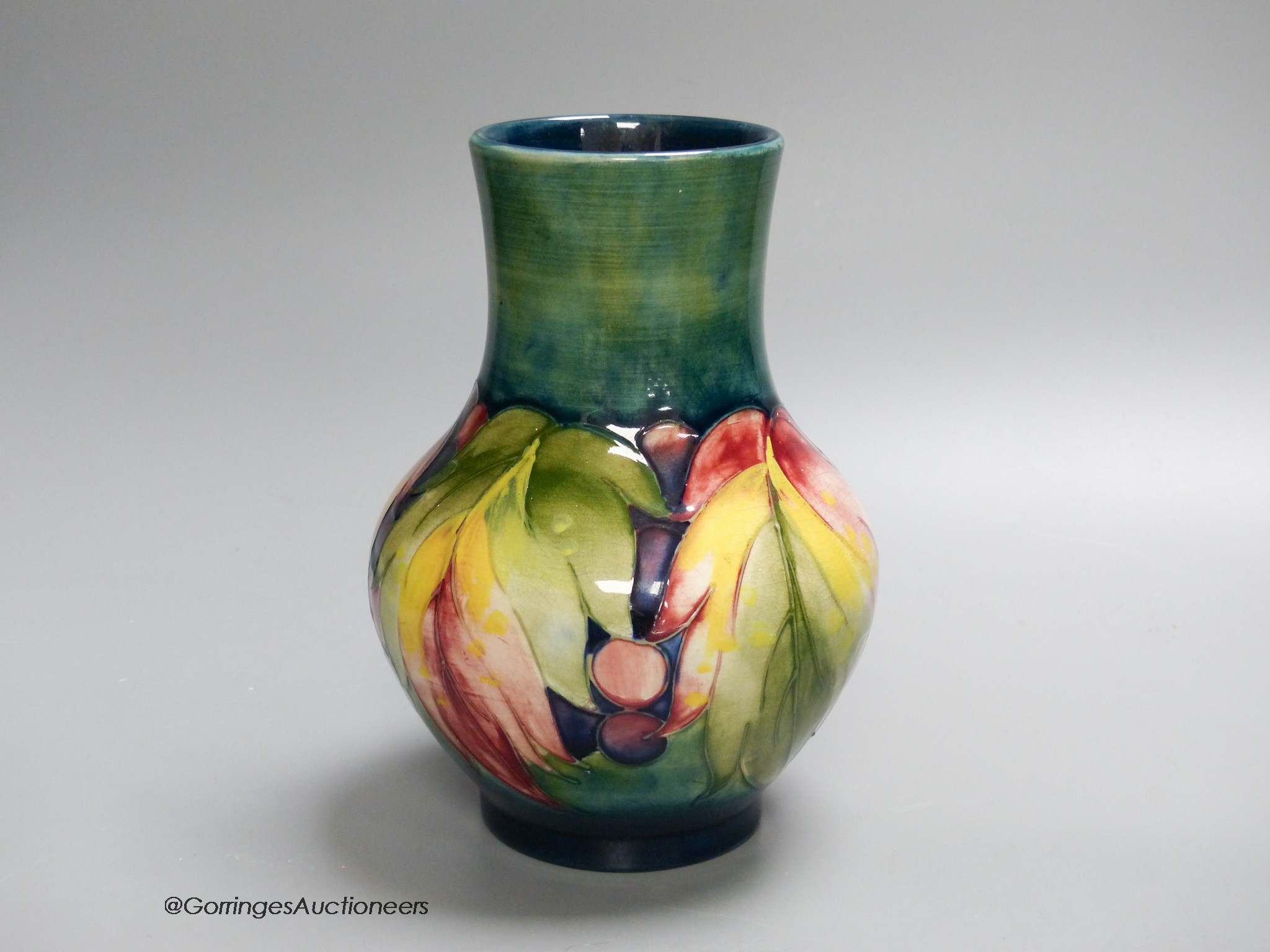 A Moorcroft leaf and berry pattern vase, 17cm high